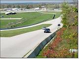  Jennifer and Jamie are shooting some photos of the straightaway.  Here Rick is receiving a pass from the BMW.